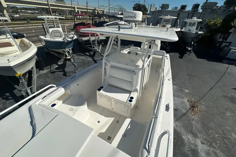 Slide: The Image of 2004 Marlago 35 FS boat with T-top and Garmin equipment, docked among other boats. - 8