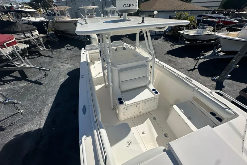 Slide: The Image of 2004 Marlago 35 FS boat with spacious deck and seating, docked among other boats. - 9