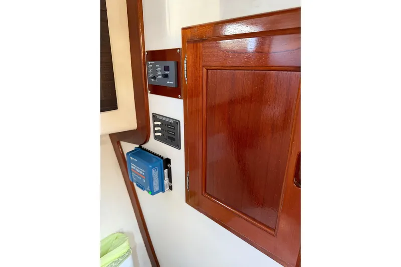 Slide: The Image of Wooden interior of a Duffy 26 boat featuring control panels and a blue electrical device. - 11