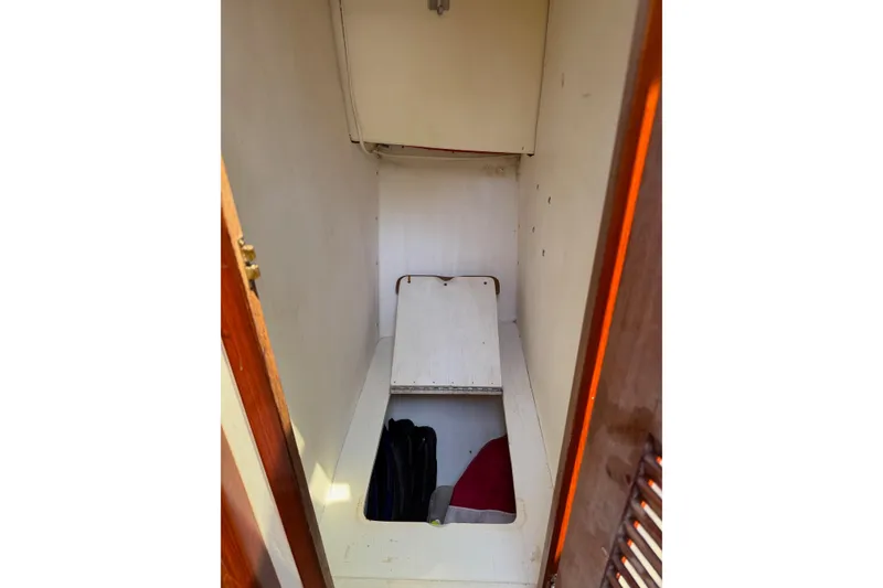 Slide: The Image of Interior storage compartment of a Duffy 26 boat with open hatch. - 14