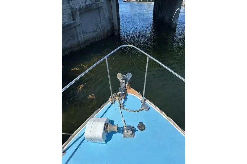 Slide: The Image of Bow of a Duffy 26 boat with anchor and chain, near a bridge over water. - 15