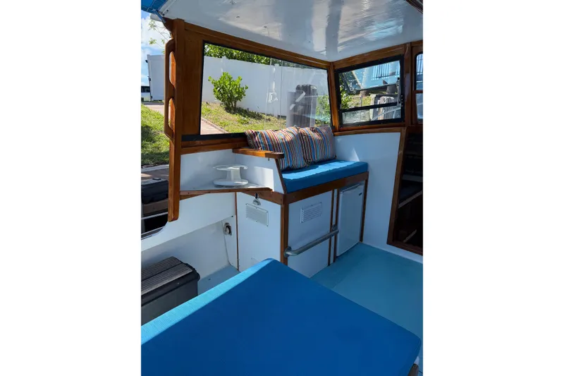 Slide: The Image of Interior of a Duffy 26 boat with blue seating and striped cushions. - 3