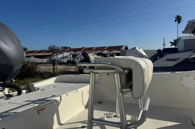 Slide: The Image of 2008 Hydra-Sports 2300 CC boat interior with seating and motor, under clear blue sky. - 7