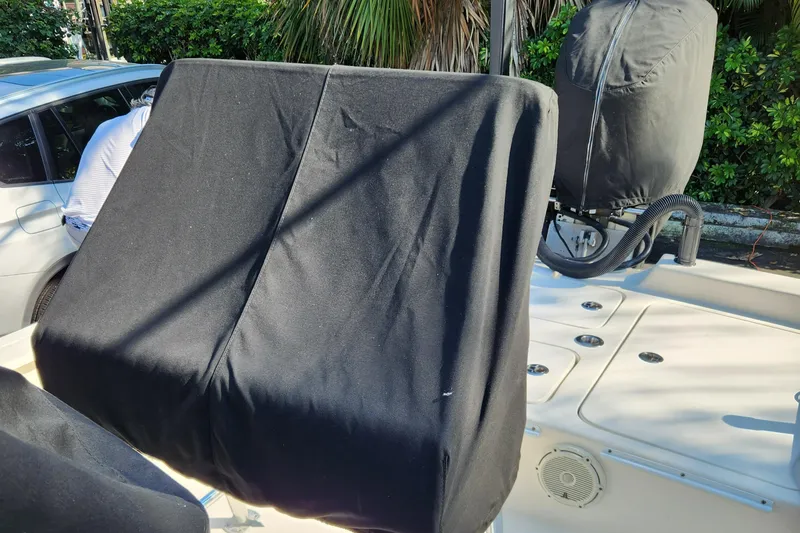 Slide: The Image of 2014 Islamorada Boatworks Morada 24 outboard motor covered, parked on pavement. - 28