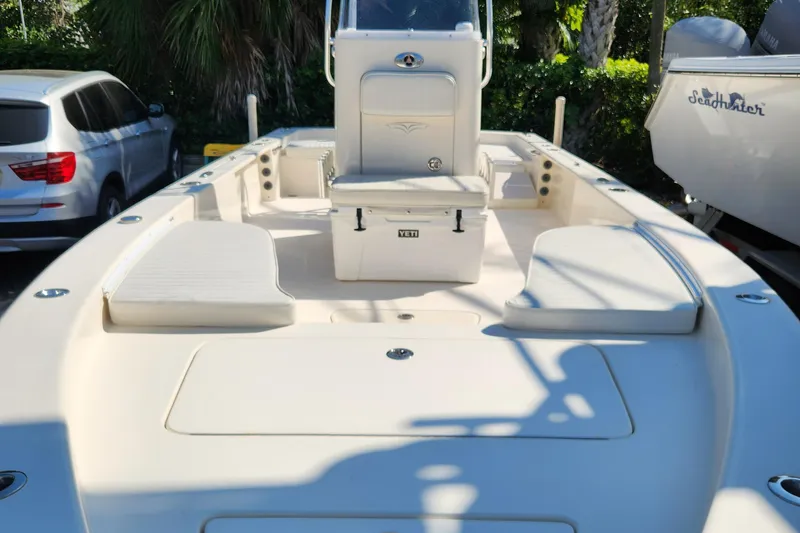 Slide: The Image of 2014 Islamorada Boatworks Morada 24 on trailer, parked near a house with trees. - 3