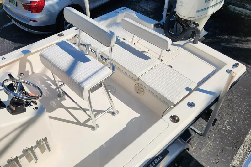 Slide: The Image of 2014 Islamorada Boatworks Morada 24 on trailer, parked outdoors near a house. - 7