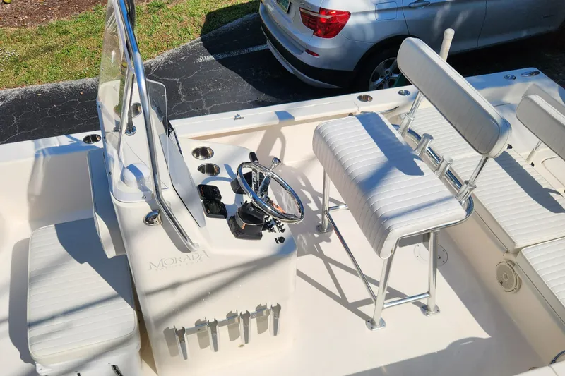 Slide: The Image of 2014 Islamorada Boatworks Morada 24 interior with seating and steering wheel. - 9