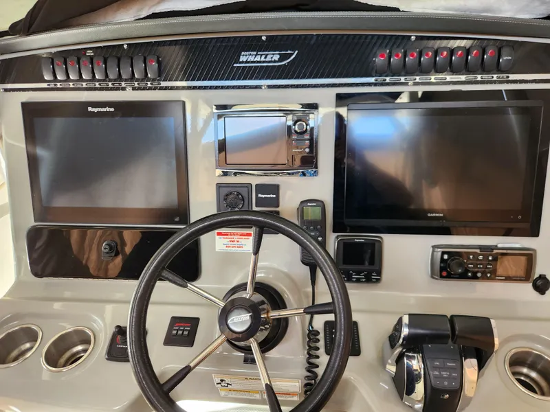 Slide: The Image of 2014 Boston Whaler 350 Outrage helm with dual screens and advanced controls. - 13