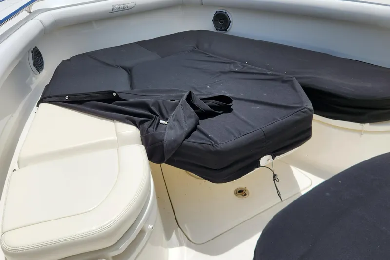 Slide: The Image of 2014 Boston Whaler 350 Outrage boat interior with black seat covers. - 16