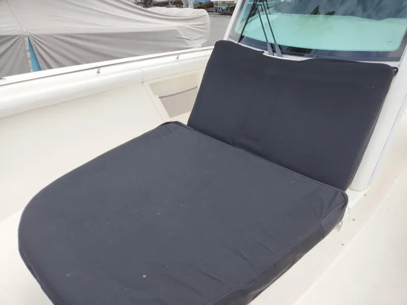 Slide: The Image of 2014 Boston Whaler 350 Outrage boat with cushioned seating area. - 20