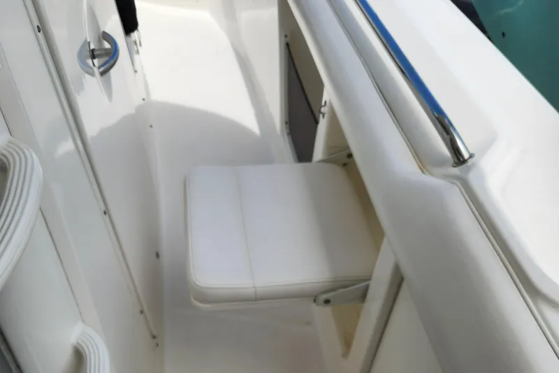 Slide: The Image of 2014 Boston Whaler 350 Outrage interior seating area with white cushioned seat. - 25