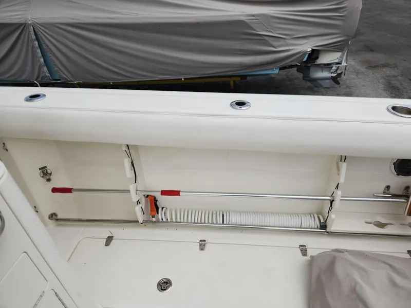 Slide: The Image of 2014 Boston Whaler 350 Outrage boat storage compartment with equipment. - 26