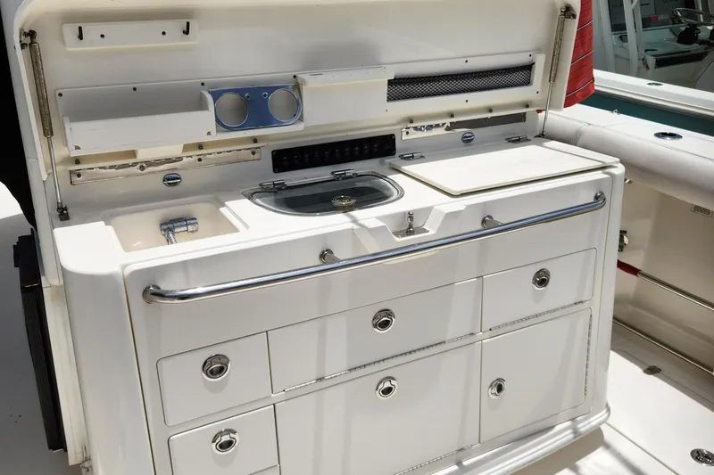 Slide: The Image of 2014 Boston Whaler 350 Outrage boat galley with storage drawers and sink. - 29