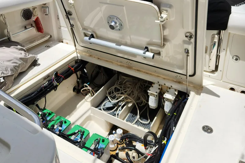 Slide: The Image of 2014 Boston Whaler 350 Outrage boat interior showing battery compartment and wiring. - 31