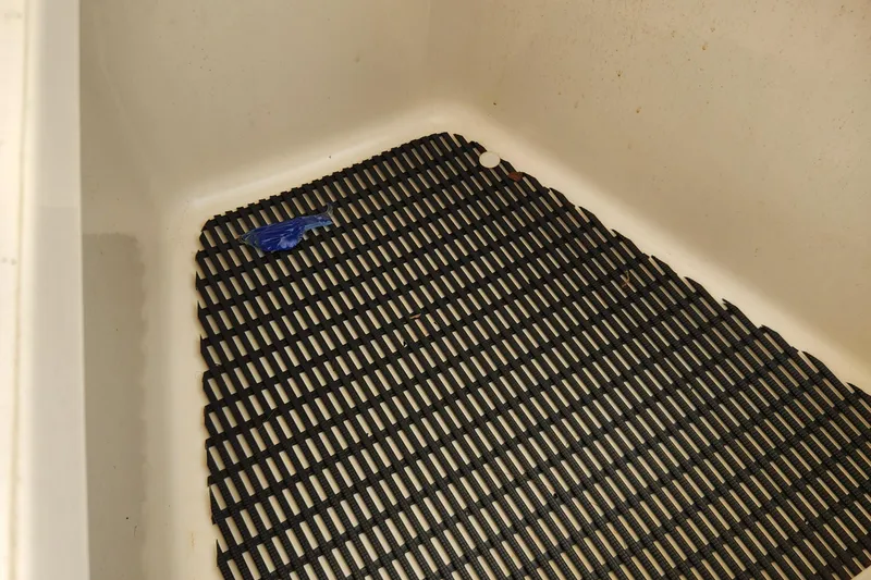 Slide: The Image of Non-slip mat in the storage compartment of a 2014 Boston Whaler 350 Outrage boat. - 35