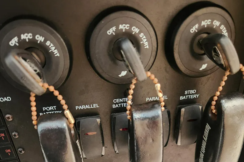 Slide: The Image of Control panel of a 2014 Boston Whaler 350 Outrage boat with ignition switches. - 38