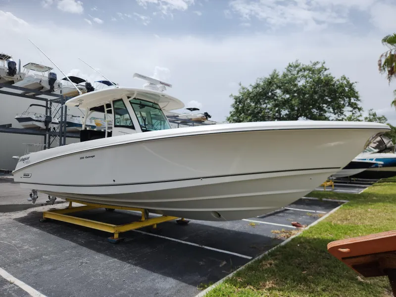 Slide: The Image of 2014 Boston Whaler 350 Outrage boat on display in a marina. - 4
