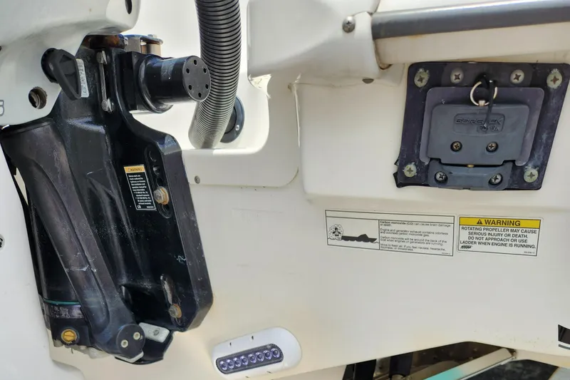 Slide: The Image of Close-up of the 2014 Boston Whaler 350 Outrage boat's engine mount and warning labels. - 44