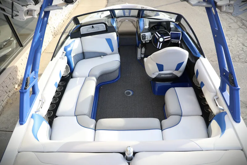 Slide: The Image of 2016 Malibu Wakesetter 20 VTX interior with blue and white seating, modern dashboard. - 6