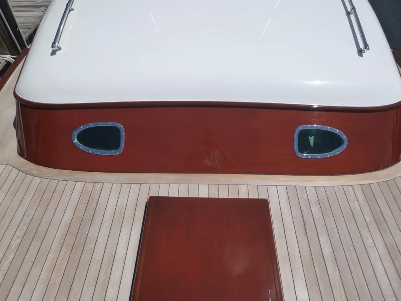 Slide: The Image of 1949 Rybovich Sport Fish boat with wooden deck and cabin windows. - 16