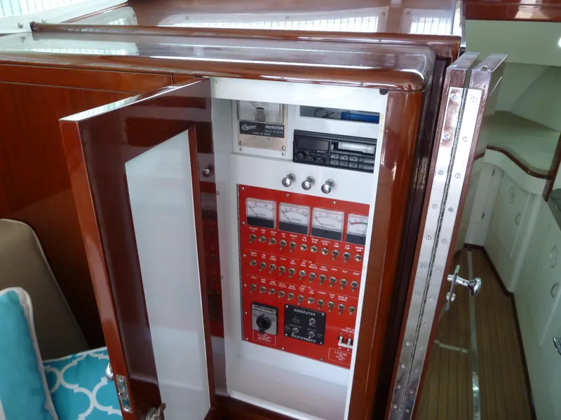 Slide: The Image of 1949 Rybovich Sport Fish boat control panel with wooden cabinet and modern instruments. - 29