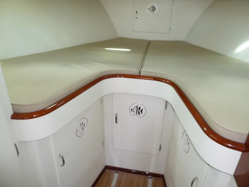 Slide: The Image of 1949 Rybovich Sport Fish cabin interior with wooden trim and cushioned seating. - 43