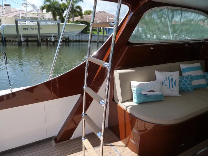 Slide: The Image of 1949 Rybovich Sport Fish boat interior with polished wood and cushioned seating. - 55