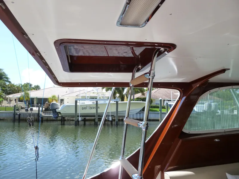 Slide: The Image of 1949 Rybovich Sport Fish boat interior with wooden flooring and stainless steel sink. - 56
