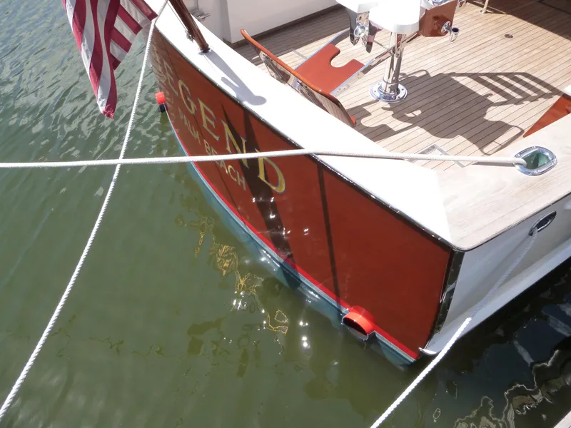 Slide: The Image of 1949 Rybovich Sport Fish interior with wooden flooring and beige seating. - 58