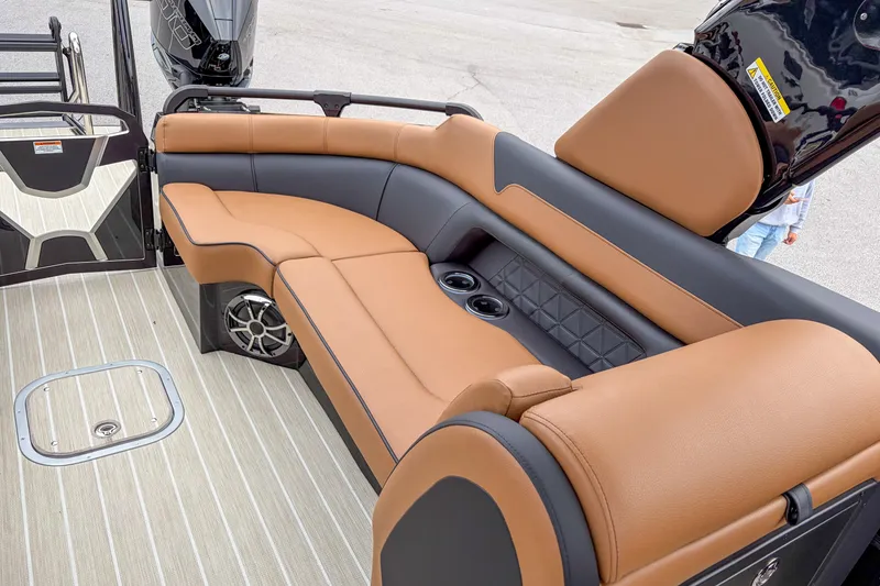 Slide: The Image of 2026 Trifecta Sport RF9 DC boat interior with tan leather seating and cup holders. - 13