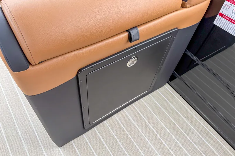 Slide: The Image of 2026 Trifecta Sport RF9 DC boat interior with tan leather seating and storage compartment. - 14