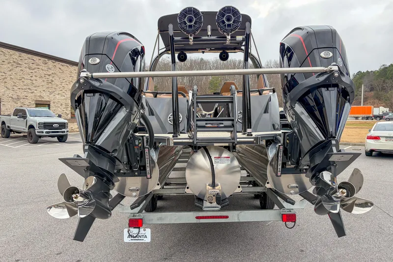Slide: The Image of 2026 Trifecta Sport RF9 DC boat with dual outboard motors in a parking lot. - 16