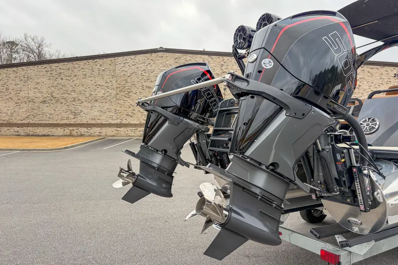 Slide: The Image of 2026 Trifecta Sport RF9 DC boat engines on display in a parking lot. - 4