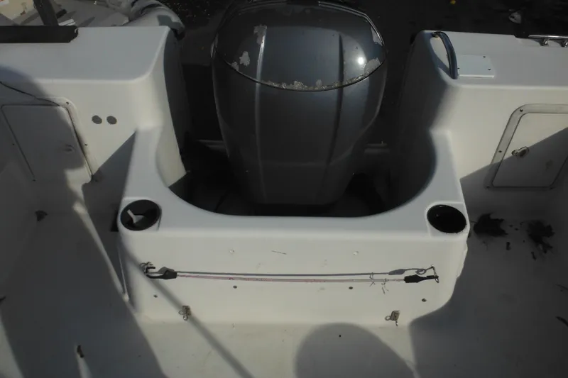 Slide: The Image of 1998 Pro-Line 201 Walkaround boat interior with motor and storage compartments. - 13