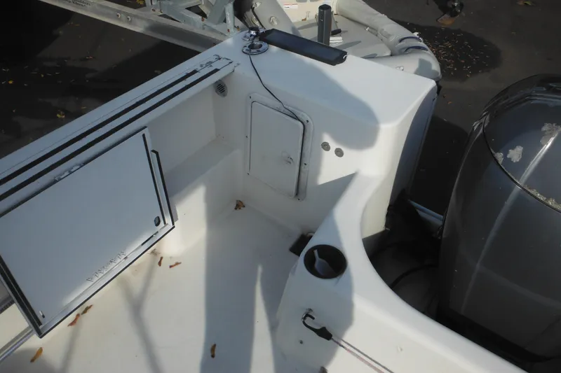 Slide: The Image of 1998 Pro-Line 201 Walkaround boat interior with storage compartments and engine view. - 14