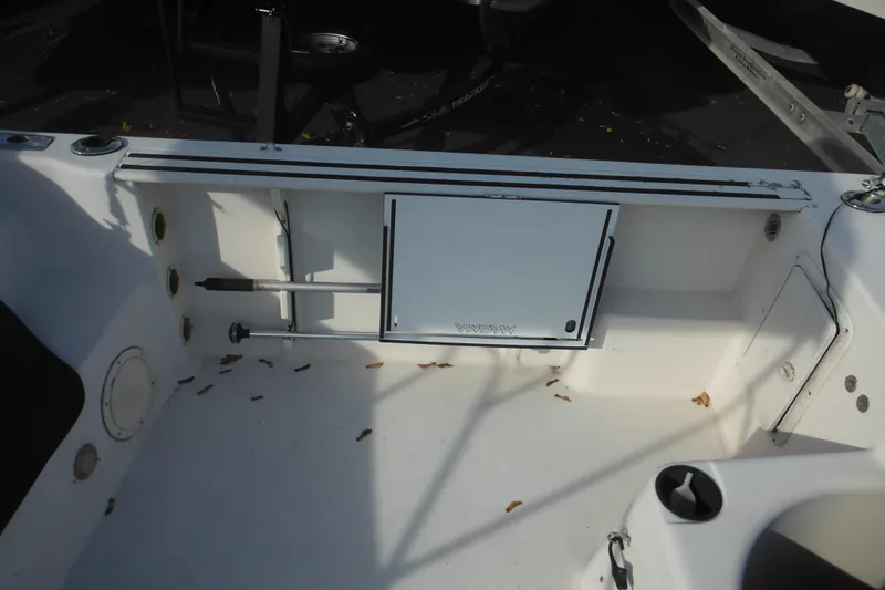 Slide: The Image of 1998 Pro-Line 201 Walkaround boat interior with storage compartment and clean deck. - 15