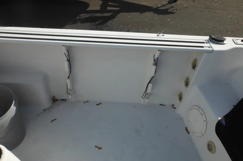 Slide: The Image of 1998 Pro-Line 201 Walkaround boat interior, showing clean deck and storage compartments. - 19