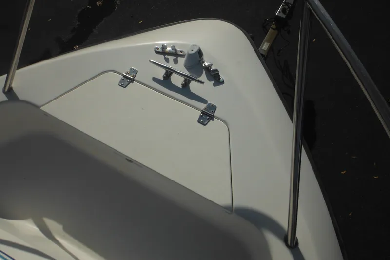 Slide: The Image of 1998 Pro-Line 201 Walkaround boat deck with stainless steel fittings and railing. - 21
