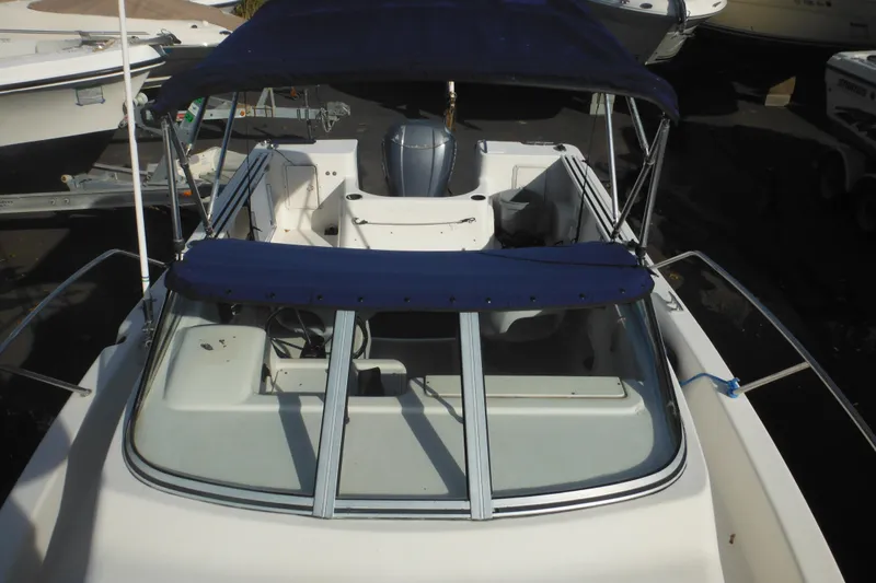 Slide: The Image of 1998 Pro-Line 201 Walkaround boat with blue canopy, viewed from above. - 24