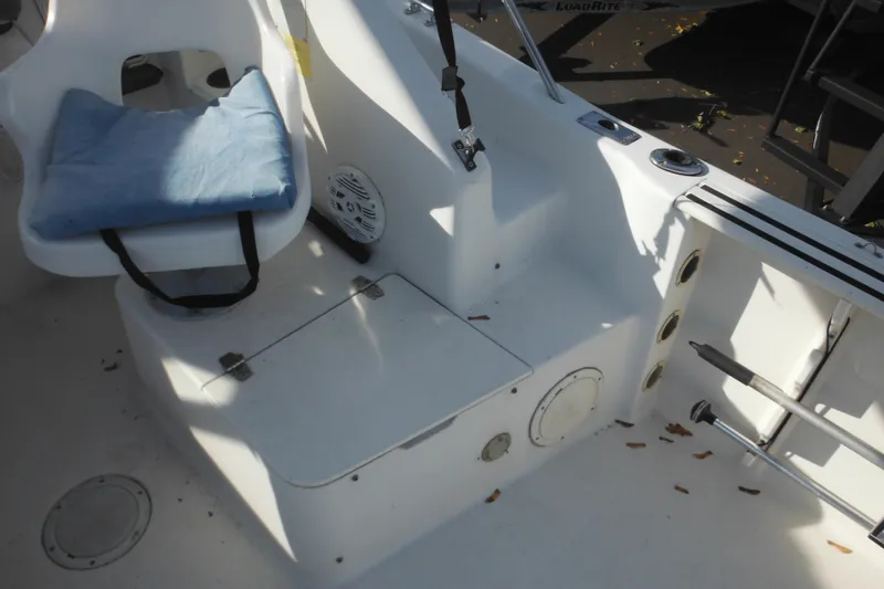 Slide: The Image of 1998 Pro-Line 201 Walkaround boat interior with seating and storage compartments. - 26