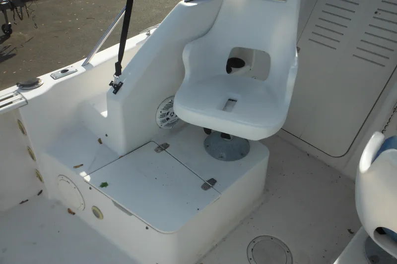 Slide: The Image of 1998 Pro-Line 201 Walkaround boat interior with white seating and storage compartments. - 29