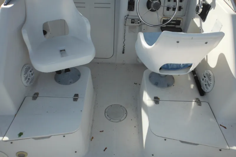 Slide: The Image of 1998 Pro-Line 201 Walkaround boat interior with dual white swivel seats and control panel. - 30