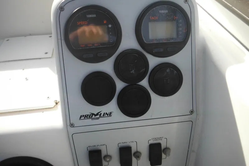 Slide: The Image of 1998 Pro-Line 201 Walkaround boat dashboard with Yamaha gauges and control switches. - 33