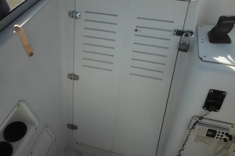 Slide: The Image of 1998 Pro-Line 201 Walkaround cabin interior with storage compartment and communication equipment. - 37