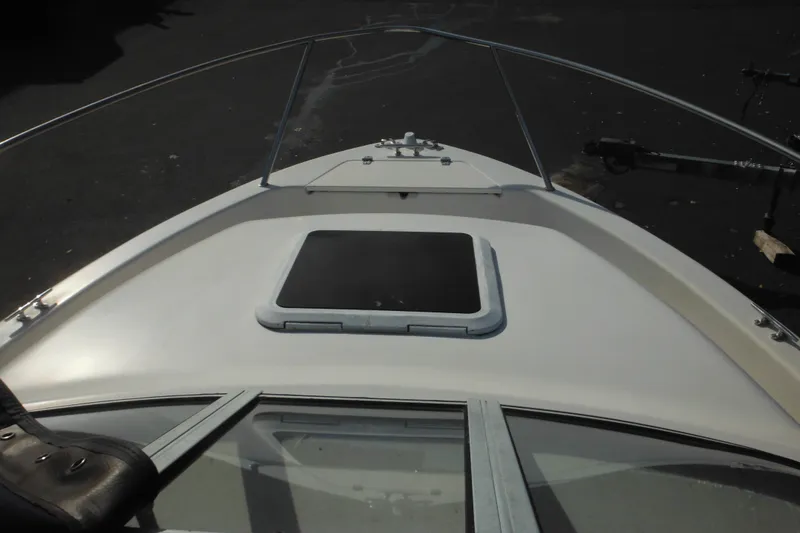 Slide: The Image of 1998 Pro-Line 201 Walkaround boat deck with hatch and railing. - 38
