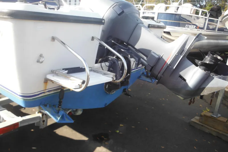 Slide: The Image of 1998 Pro-Line 201 Walkaround boat with outboard motor on trailer. - 4