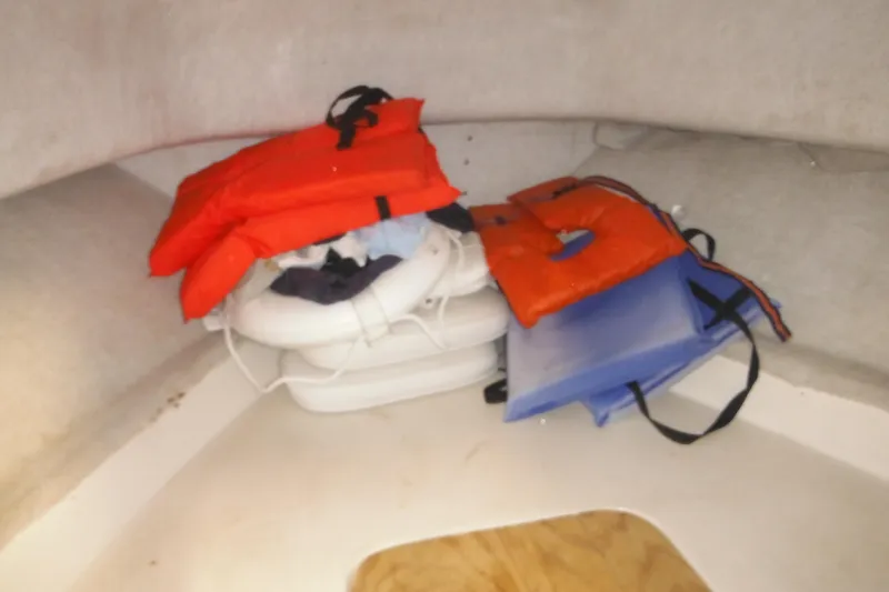 Slide: The Image of Life jackets and cushions stored in a 1998 Pro-Line 201 Walkaround boat cabin. - 41
