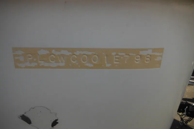 Slide: The Image of 1998 Pro-Line 201 Walkaround boat hull identification number on weathered surface. - 5