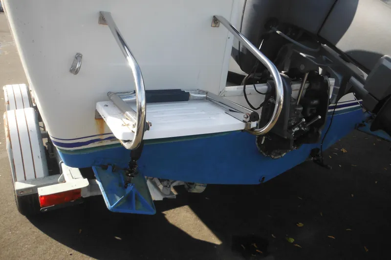 Slide: The Image of 1998 Pro-Line 201 Walkaround boat stern with trailer and outboard motor components. - 9
