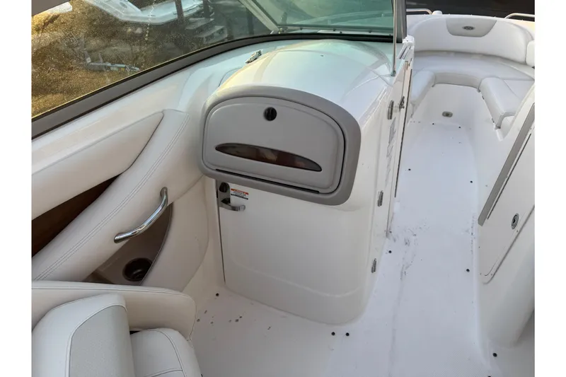 Slide: The Image of 2007 Chaparral 256 SSi boat interior with white seating and storage compartment. - 10
